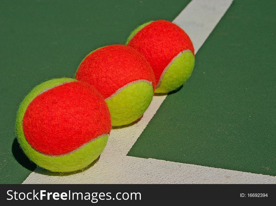 Three Balls On A Green Court