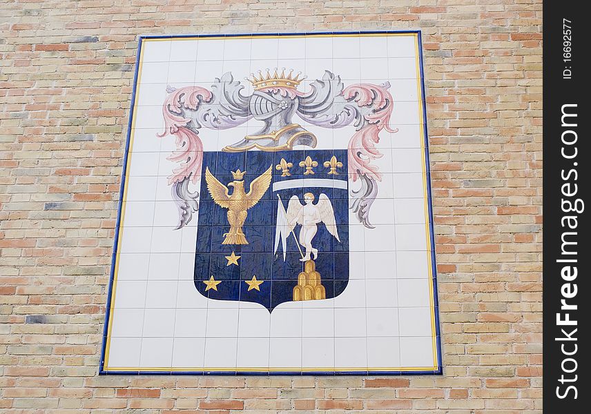 Italy, medieval coat of arms made of tiles on a wall
