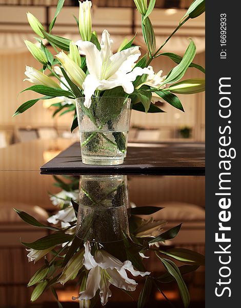Beautiful lily in glass vase on the table. Beautiful lily in glass vase on the table