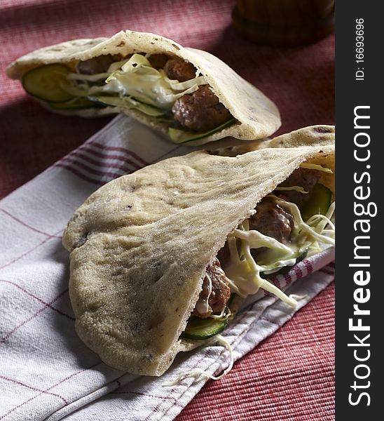 Bread pie filled with meat balls and cheese and vegetables