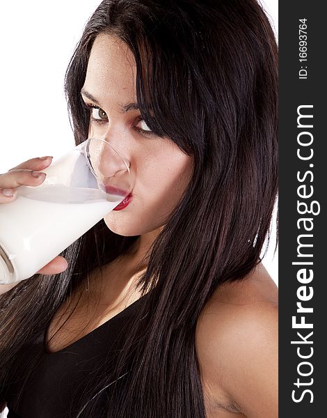 A woman is drinking a glass of milk. A woman is drinking a glass of milk.