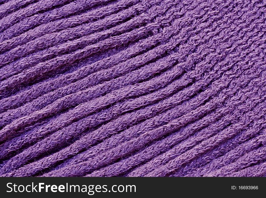 a background of a close up of a knitted scarf fringe. a background of a close up of a knitted scarf fringe