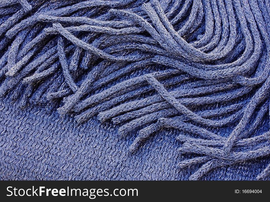 a background of a scarf with a fringe. a background of a scarf with a fringe
