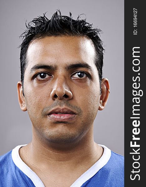 Indian man portrait in studio, he has one lazy eye. Indian man portrait in studio, he has one lazy eye