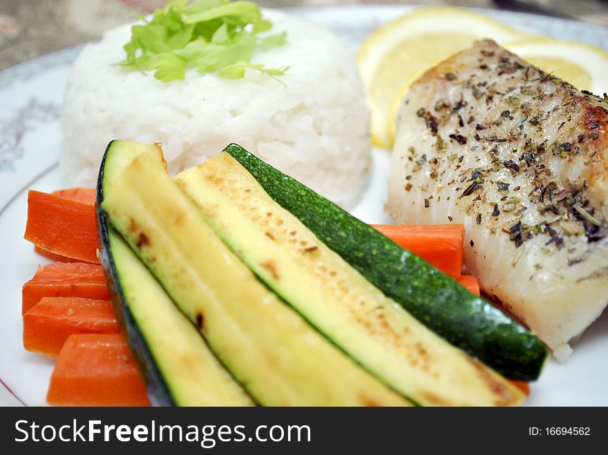 Fresh and delicius fish, rice and vegetable plate