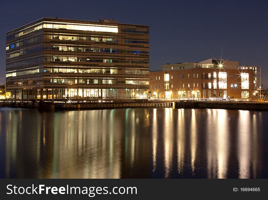 An office building by the harbour at night. An office building by the harbour at night