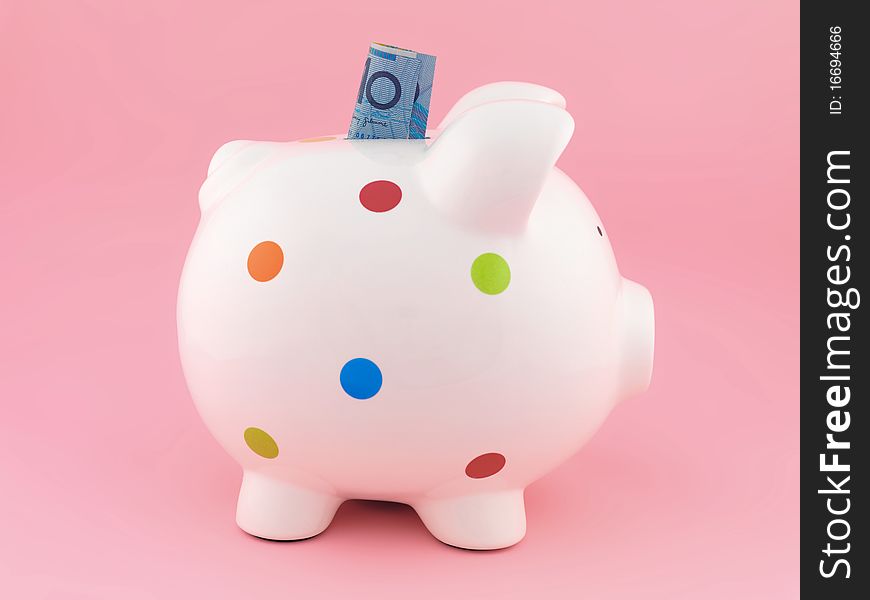 A piggy bank isolated against a pink background