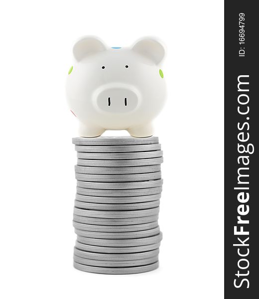 Silver play money with a piggy bank isolated against a white background