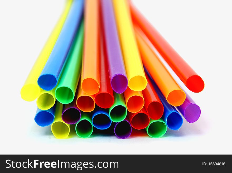 Several multicolored straws laying flat on a tabletop
