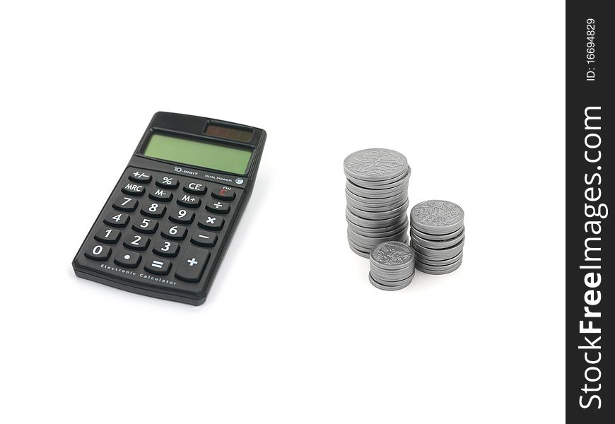 Silver play money and a calculator isolated against a white background