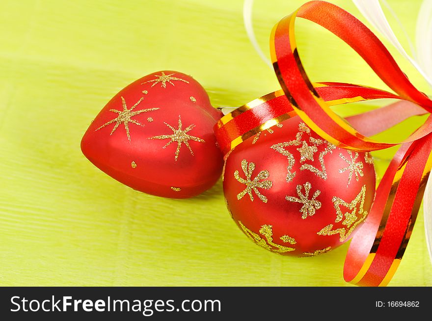 Two Christmas balls on a green background