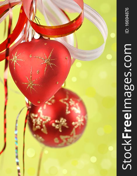 Christmas balls on a green background and abstract bokeh with space