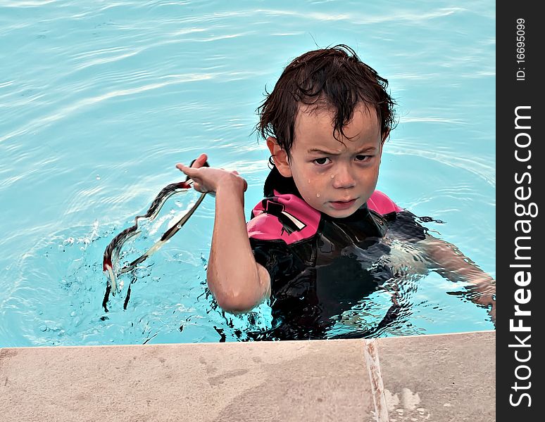 Small boy getting angry in pool. Small boy getting angry in pool.