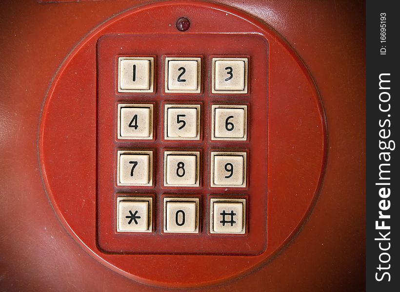 Old white telephone key number on red