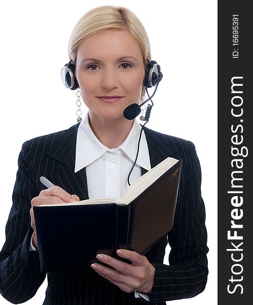 Call center woman with headset and write in a notebook. Call center woman with headset and write in a notebook