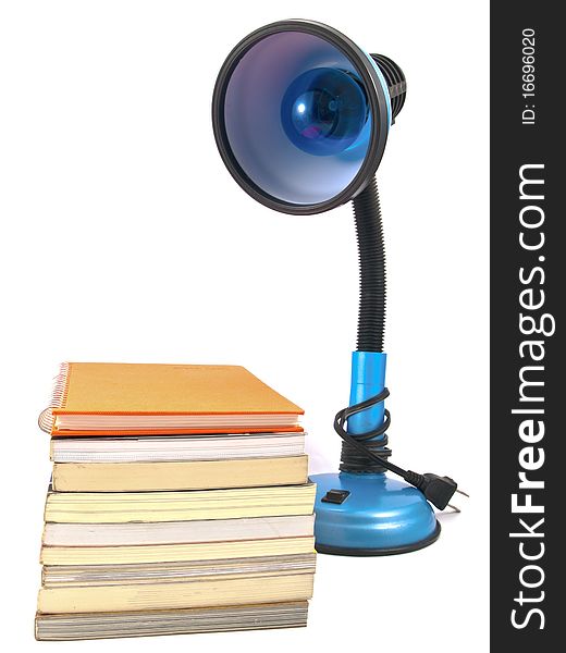 Desk lamp and book heap isolated on white background. Desk lamp and book heap isolated on white background