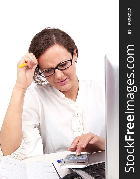 Businesswoman holding pencil in hand, sitting in office