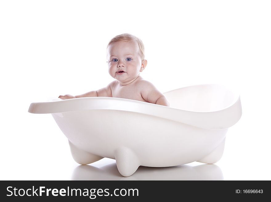 Boy in white bath tub on white