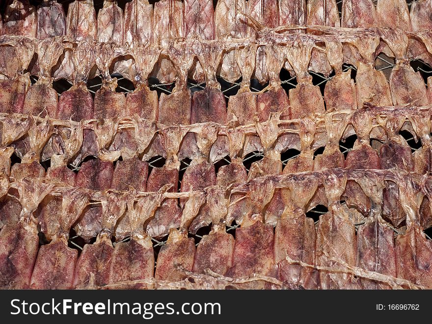 Dried and flatten squids in a Thai market. Dried and flatten squids in a Thai market