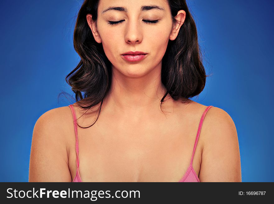 Beautiful woman portrait isolated over blue background