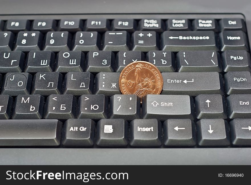 One dollar on a black computer keyboard. Studio shot. One dollar on a black computer keyboard. Studio shot