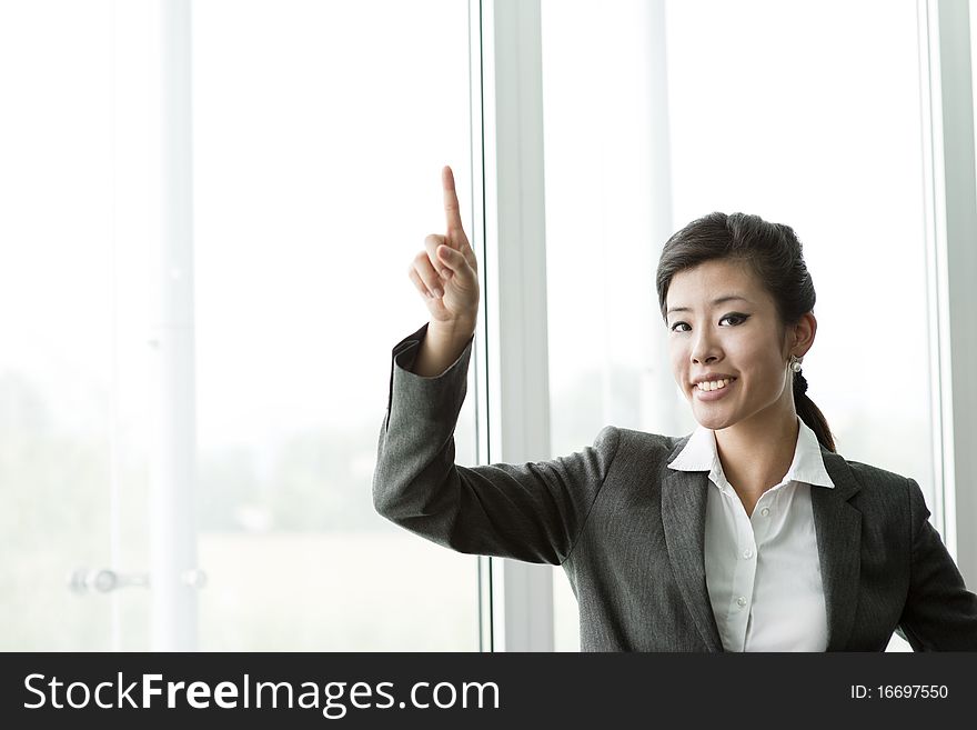 Chinese Businesswoman Pointing at Copy-space