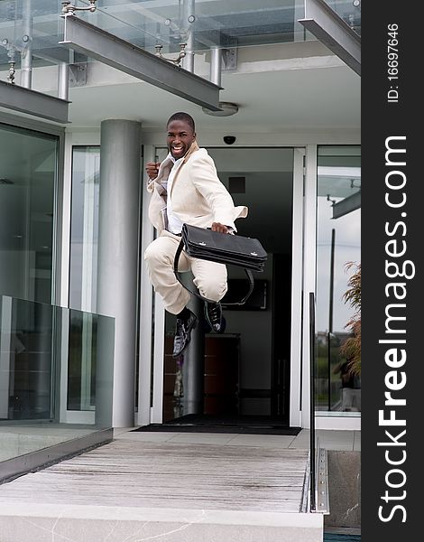 Businessman jumping of happiness outside his office
