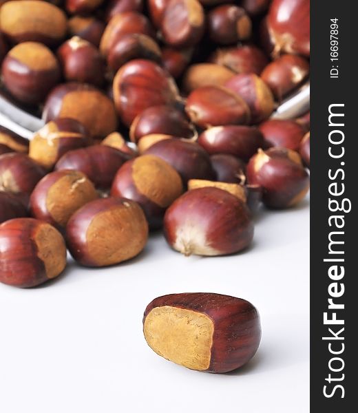 Quantity of chestnuts and overturned one isolated in the foreground. Quantity of chestnuts and overturned one isolated in the foreground