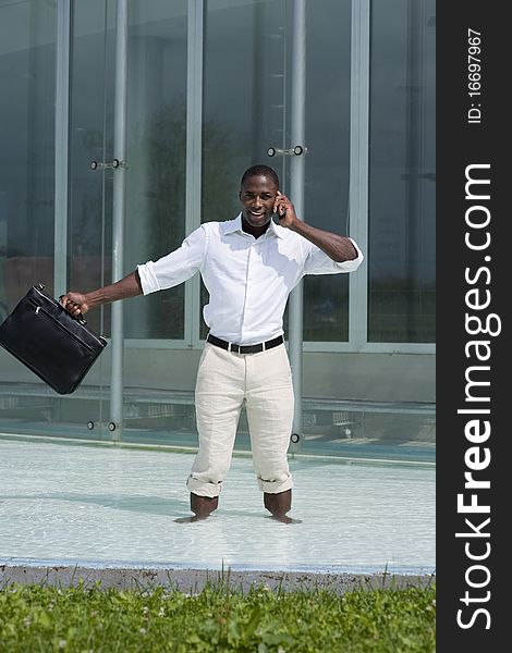 Businessman inside a pool speaking on the phone