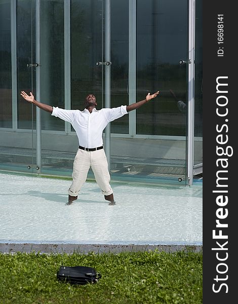 Businessman in the pool outside his office;  he could be excited beacuse he has just resigned. Businessman in the pool outside his office;  he could be excited beacuse he has just resigned