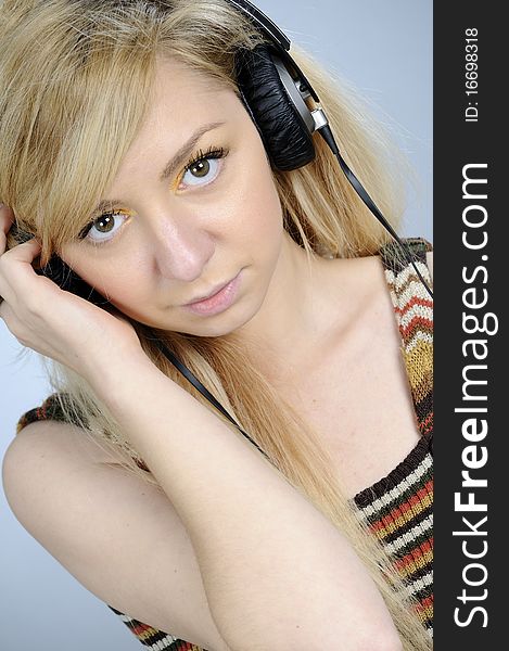 Young woman listening music on headphones. Young woman listening music on headphones