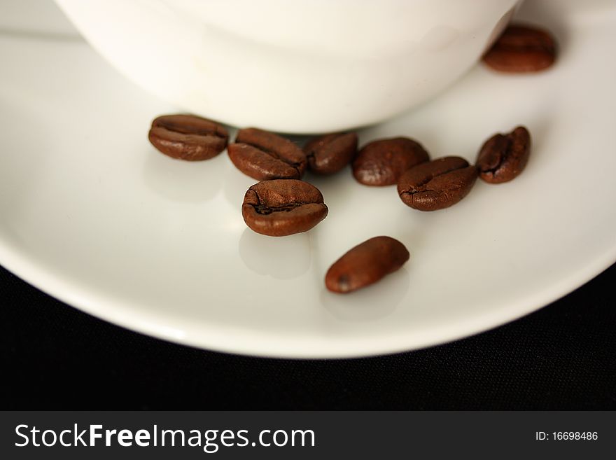 Coffee cup on black background and coffee beans. Coffee cup on black background and coffee beans