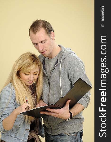 Blonde student woman signing contract in studio. Blonde student woman signing contract in studio