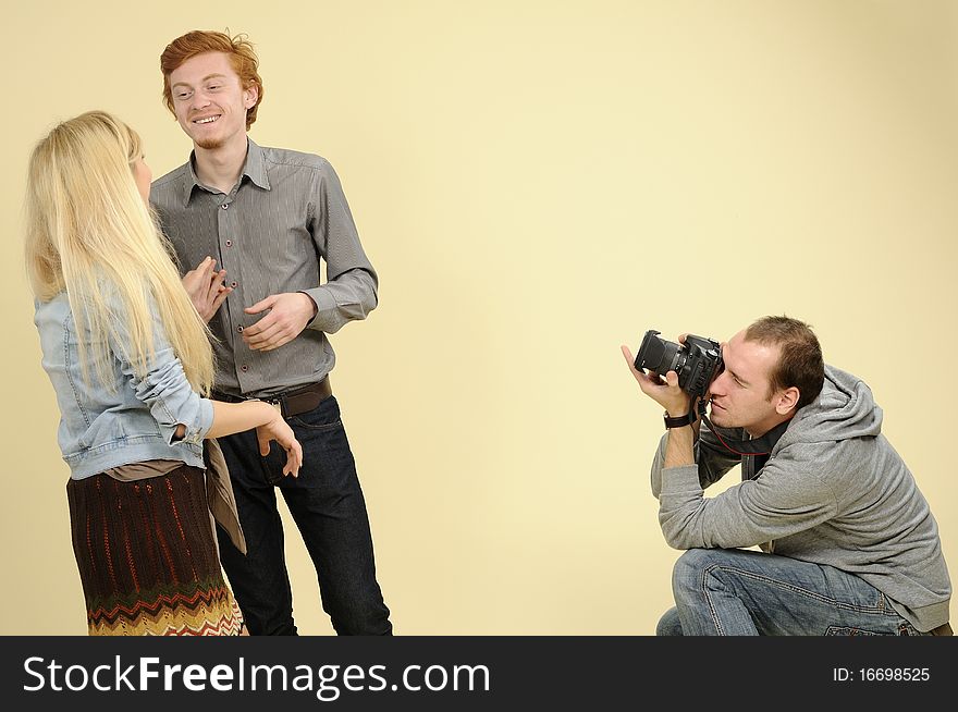 Young photographer creating photos with students expressing friendship. Young photographer creating photos with students expressing friendship