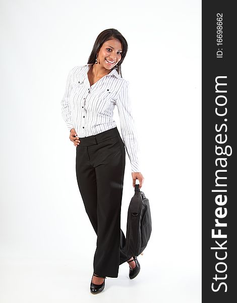 Beautiful young business woman with big happy smile standing in a relaxed fun pose wearing heels holding laptop bag in one hand. Beautiful young business woman with big happy smile standing in a relaxed fun pose wearing heels holding laptop bag in one hand