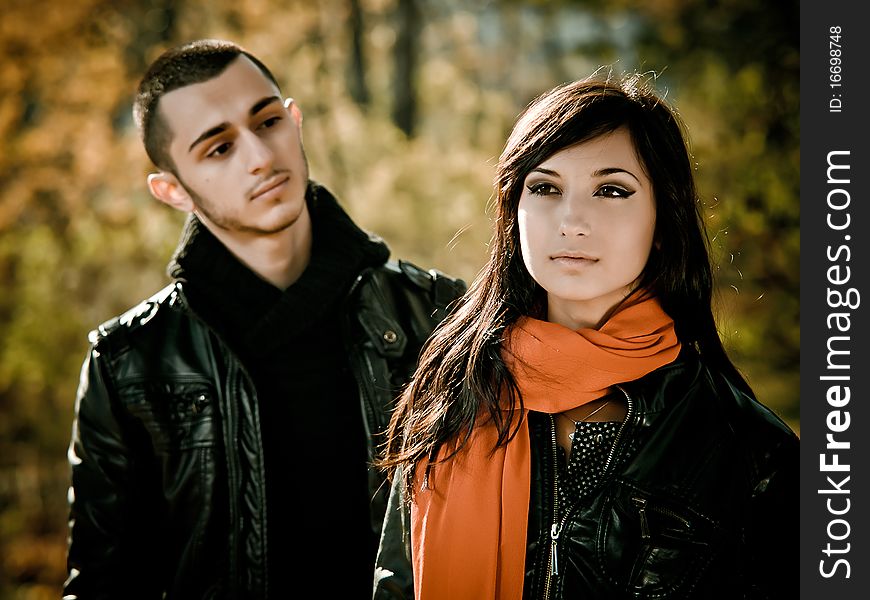 Young man is looking at beauty girl in fall outdoor. Young man is looking at beauty girl in fall outdoor