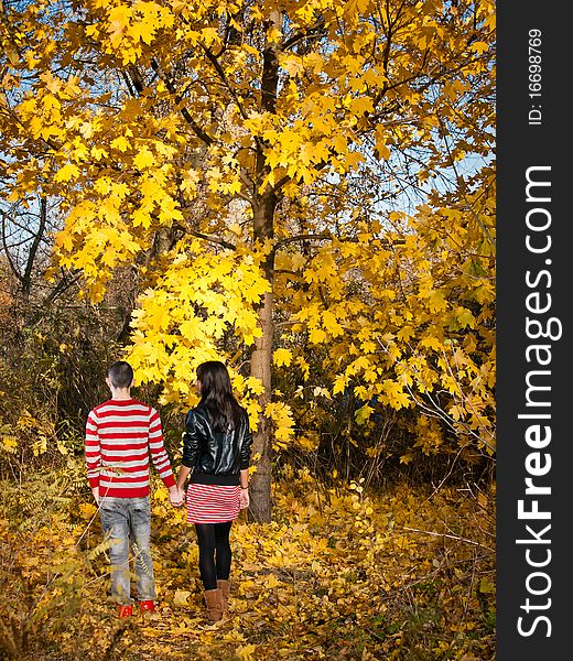 Couple of young man and girl in a fall forest. Couple of young man and girl in a fall forest