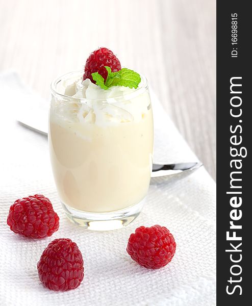 Vanilla dessert in a glass with raspberry