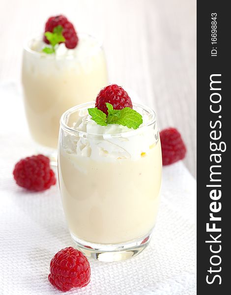 Vanilla cream with whipped cream and raspberries. Vanilla cream with whipped cream and raspberries