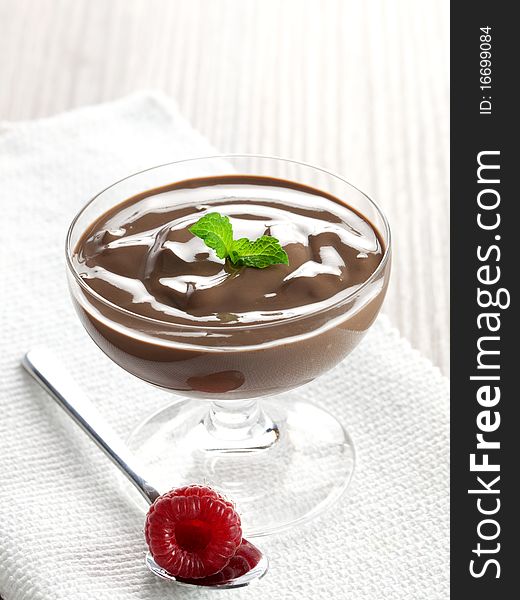 Chocolate cream in a glass with spoon
