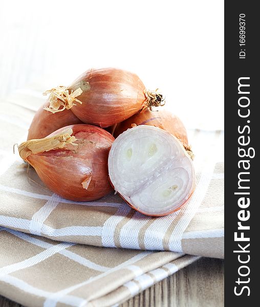 Fresh shallots on a dishtowel