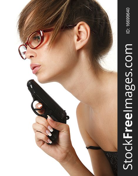 Attractive young woman in red glasses with handgun over white. Attractive young woman in red glasses with handgun over white