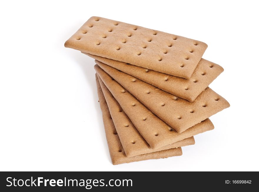 Stack of dark biscuits isolated over white. Stack of dark biscuits isolated over white