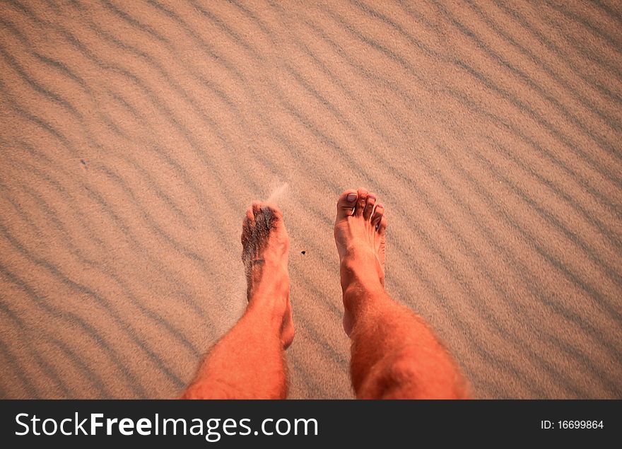 Feet jumping on beach in sand ripples. Feet jumping on beach in sand ripples