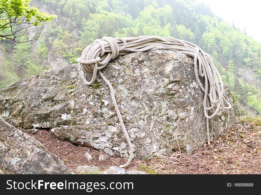 Climbing rope on rock in black forest