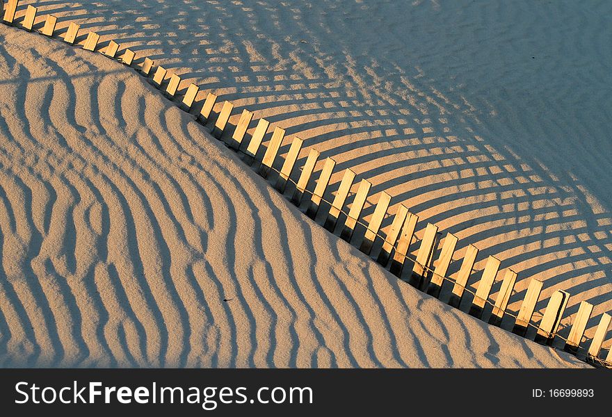 Fence and shadows on french atlantic dune. Fence and shadows on french atlantic dune