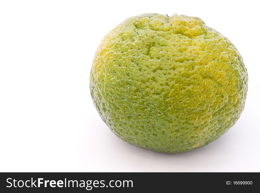 Green mandarin isolated over white