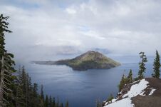 Fog Breaking Over Crater Lake Stock Photo