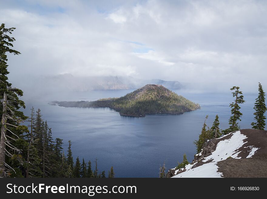 Fog breaks over Crater Lake in Oregon, letting the sun shine through to the water`s surface and allowing tourists a glimpse of the winter landscape. Fog breaks over Crater Lake in Oregon, letting the sun shine through to the water`s surface and allowing tourists a glimpse of the winter landscape.
