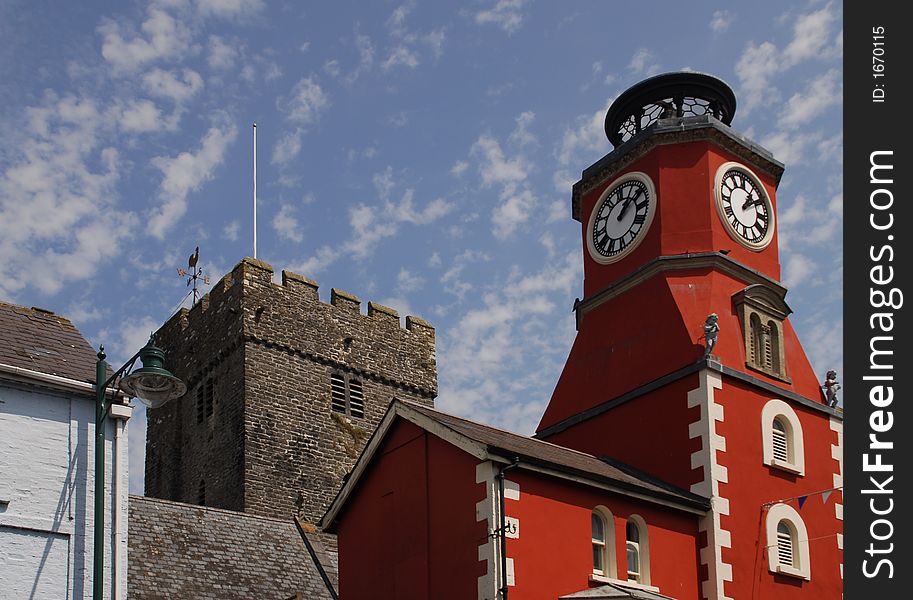 A red house and an old church sit next to each other in a small town in south-west Wales. A red house and an old church sit next to each other in a small town in south-west Wales.